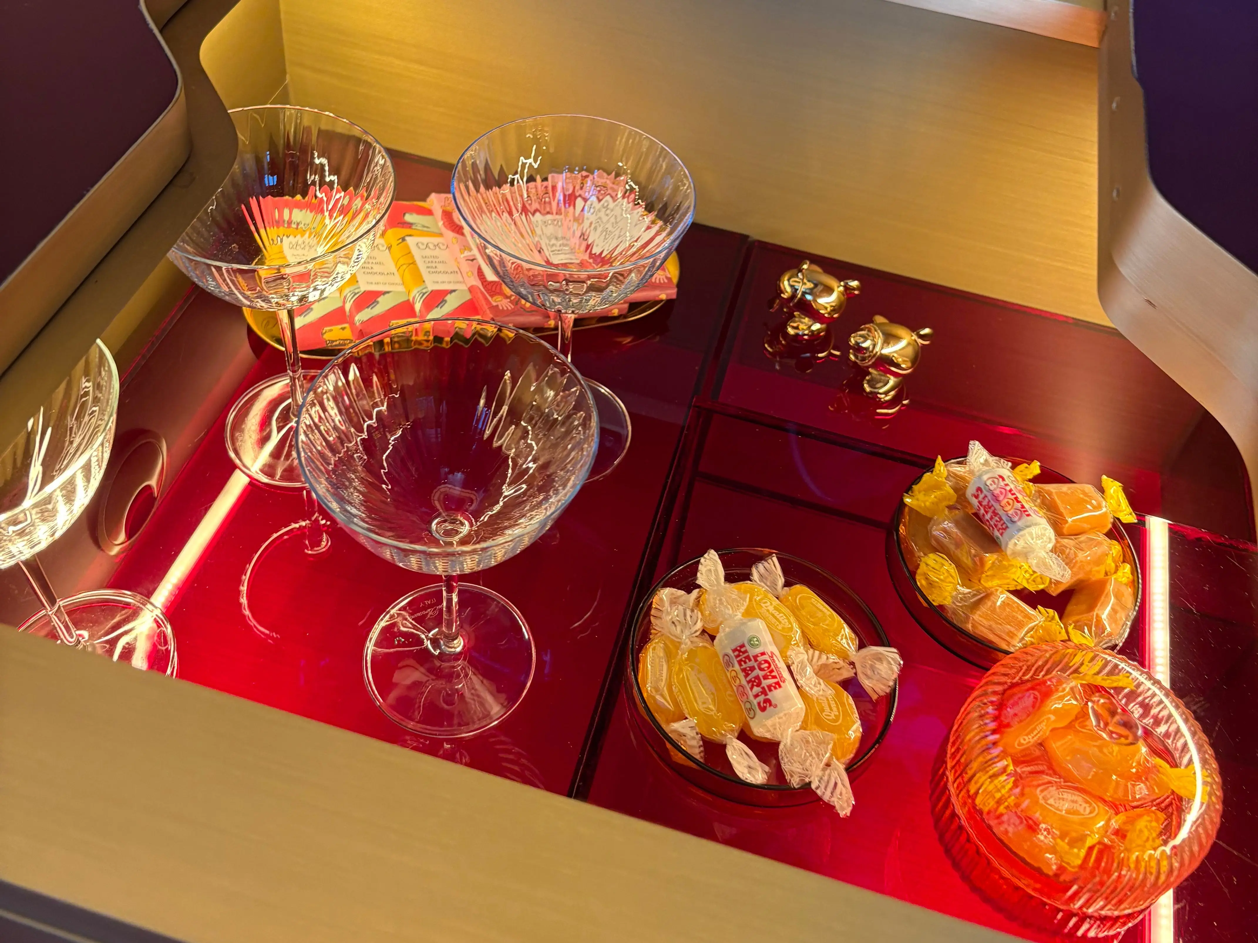 The table opening where glasses, treats, and salt and pepper shakes are stored.