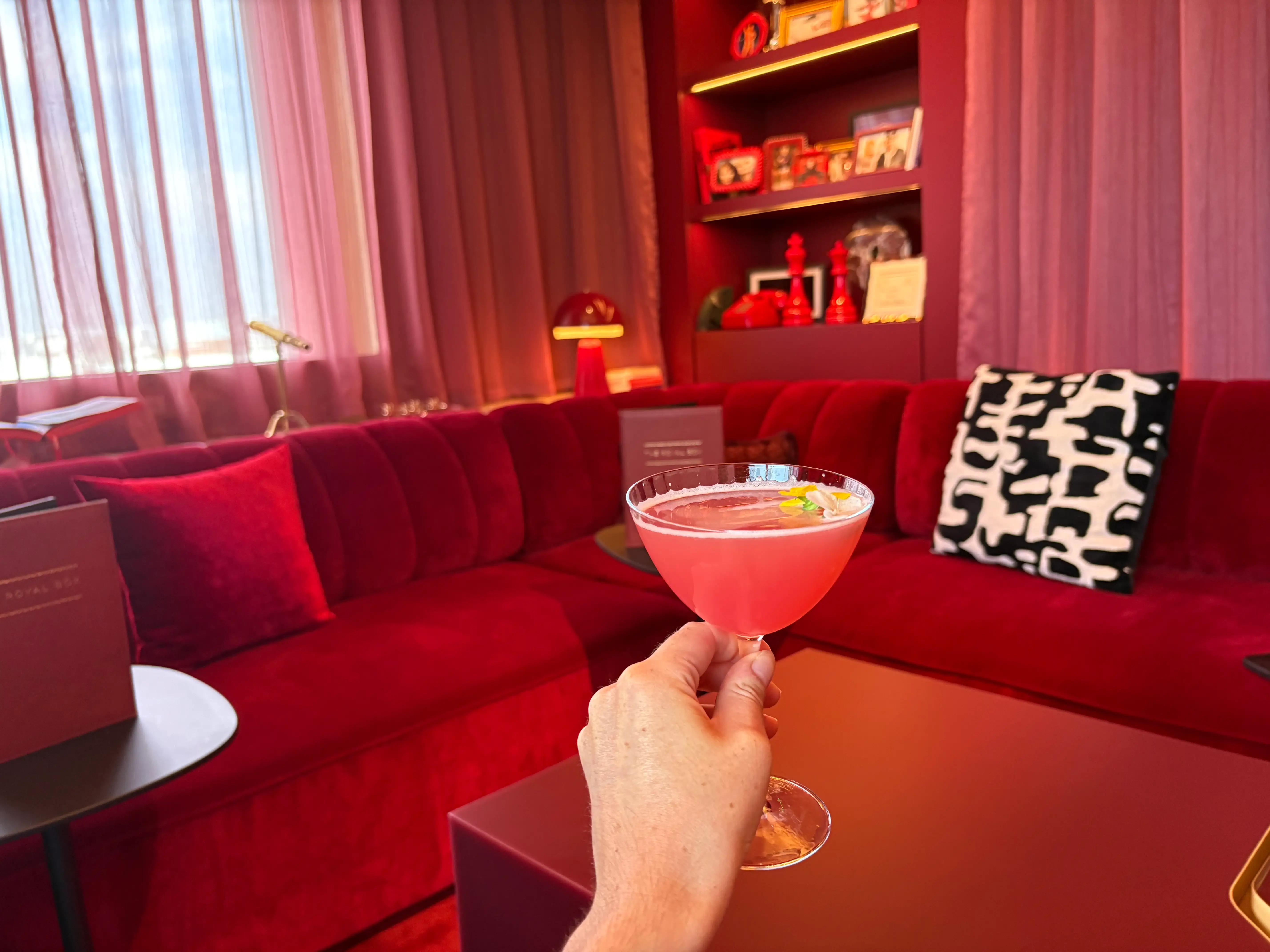 The author holding the Drama Queen cocktail.