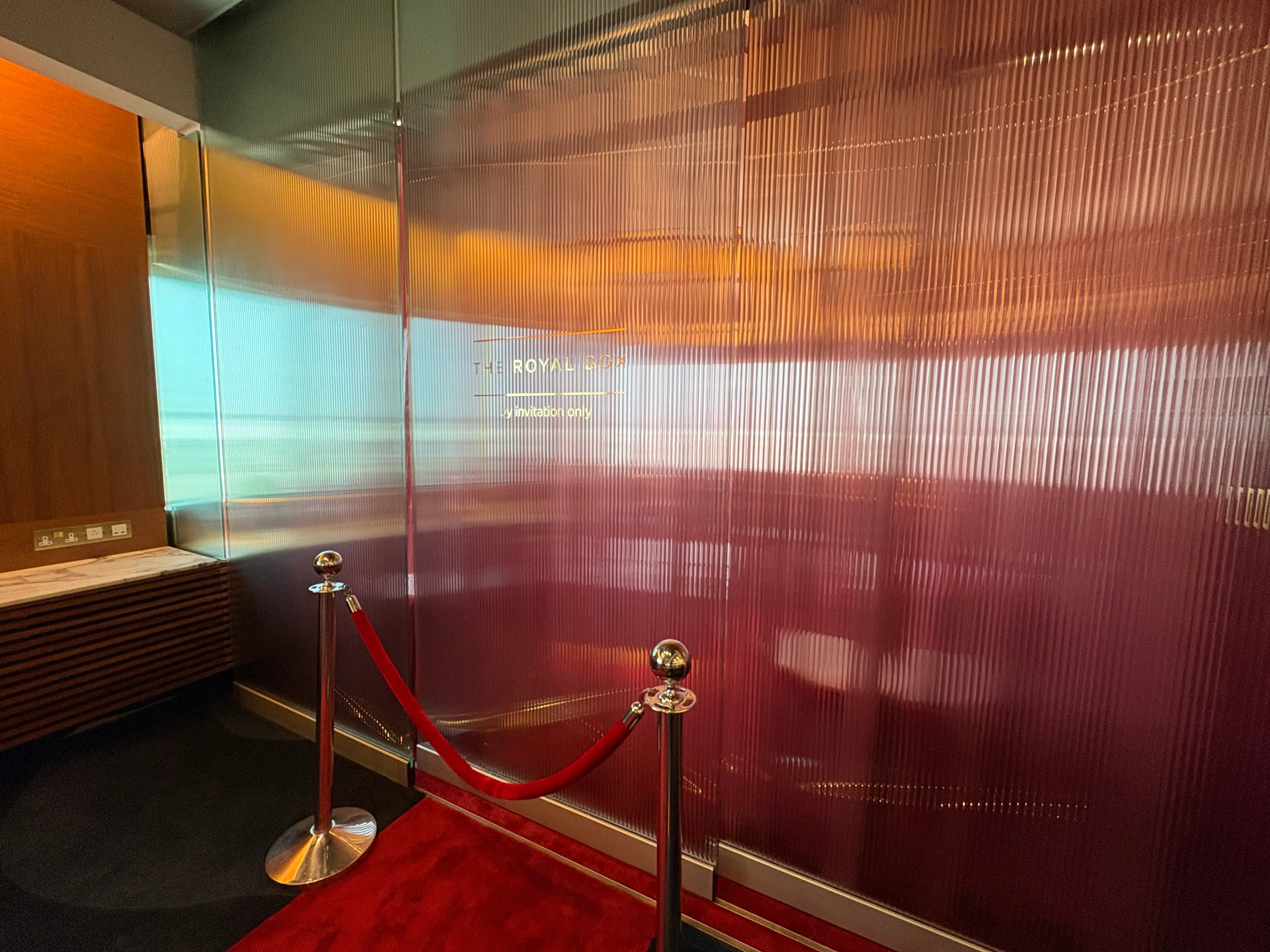 The invite-only Royal Box sits behind a clouded window and red velvet rope.