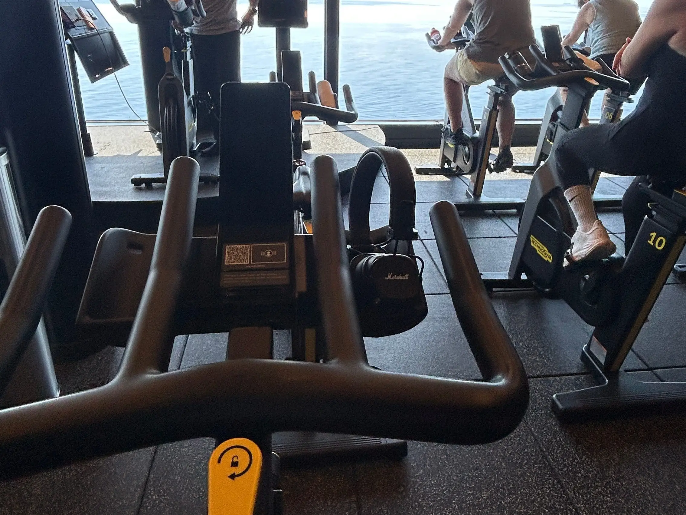 The writer's point of view on a spin bike at a workout class aboard a Virgin Voyages cruise ship.
