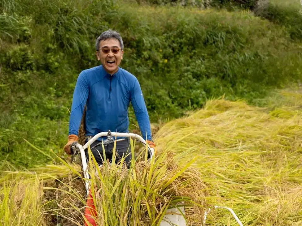 A Japanese man working in the Japanese countryside.