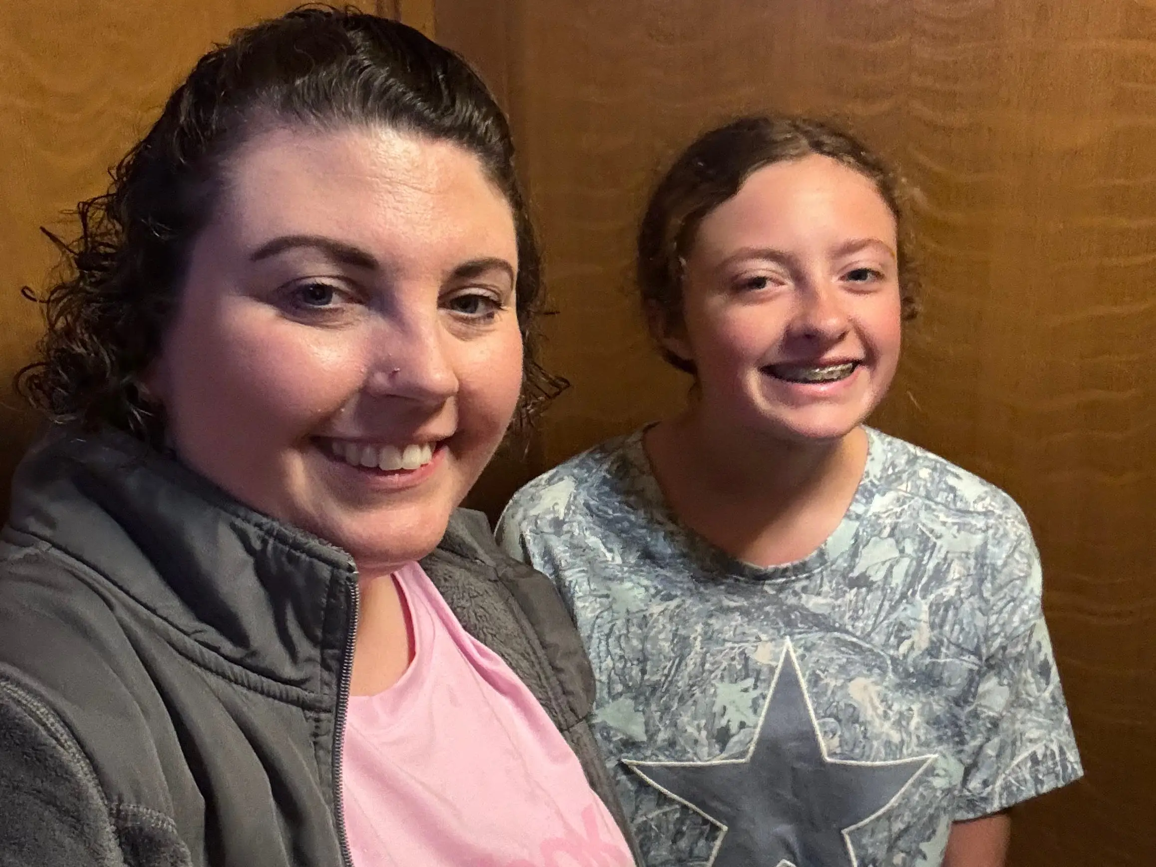 A mom and daughter taking a selfie.