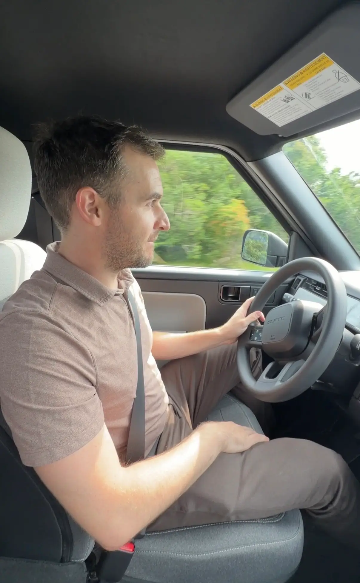 Ben Shimkus, a reporter at Business Insider, behind the wheel of a Slate truck.