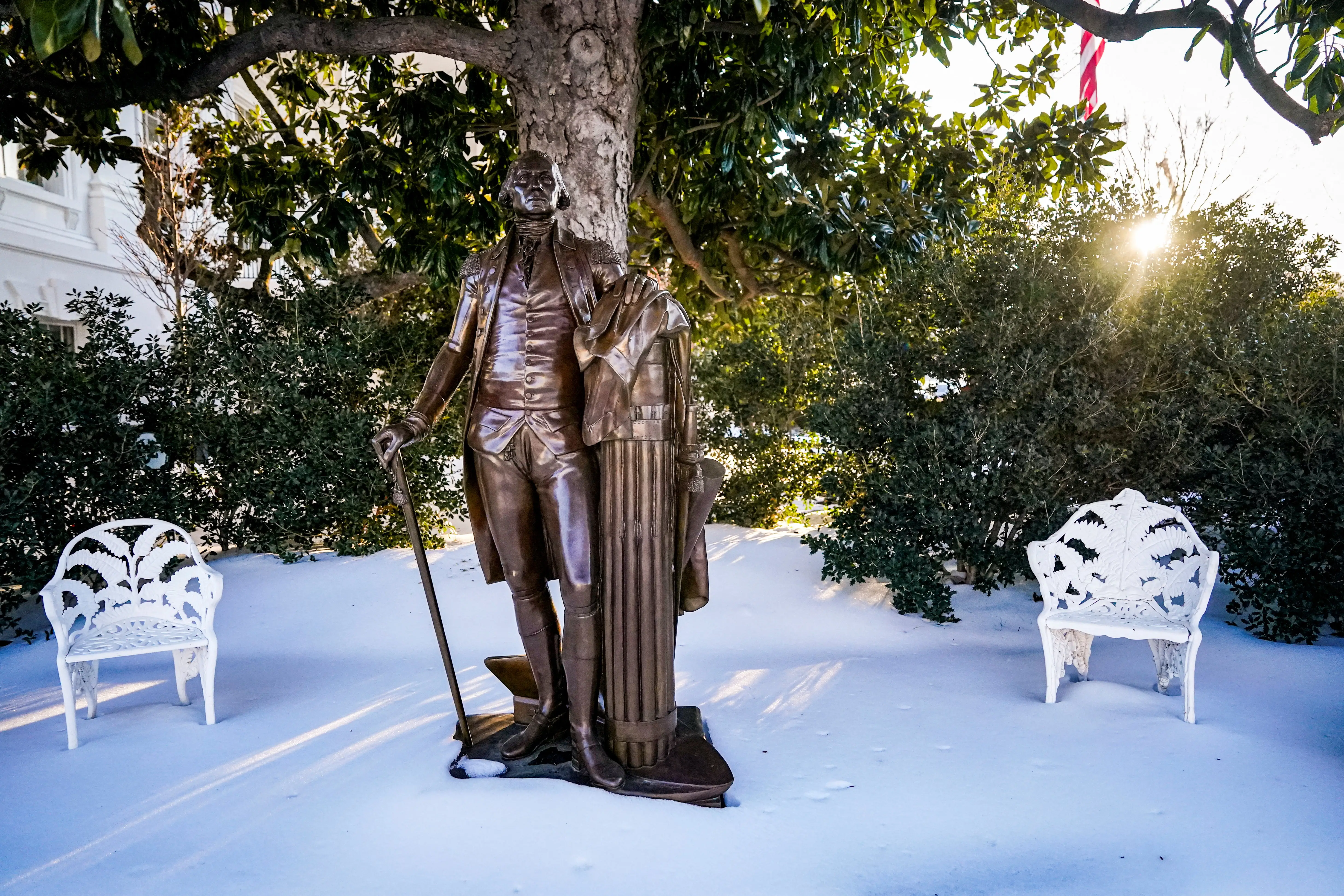A bronze statue of George Washington in the Rose Garden.
