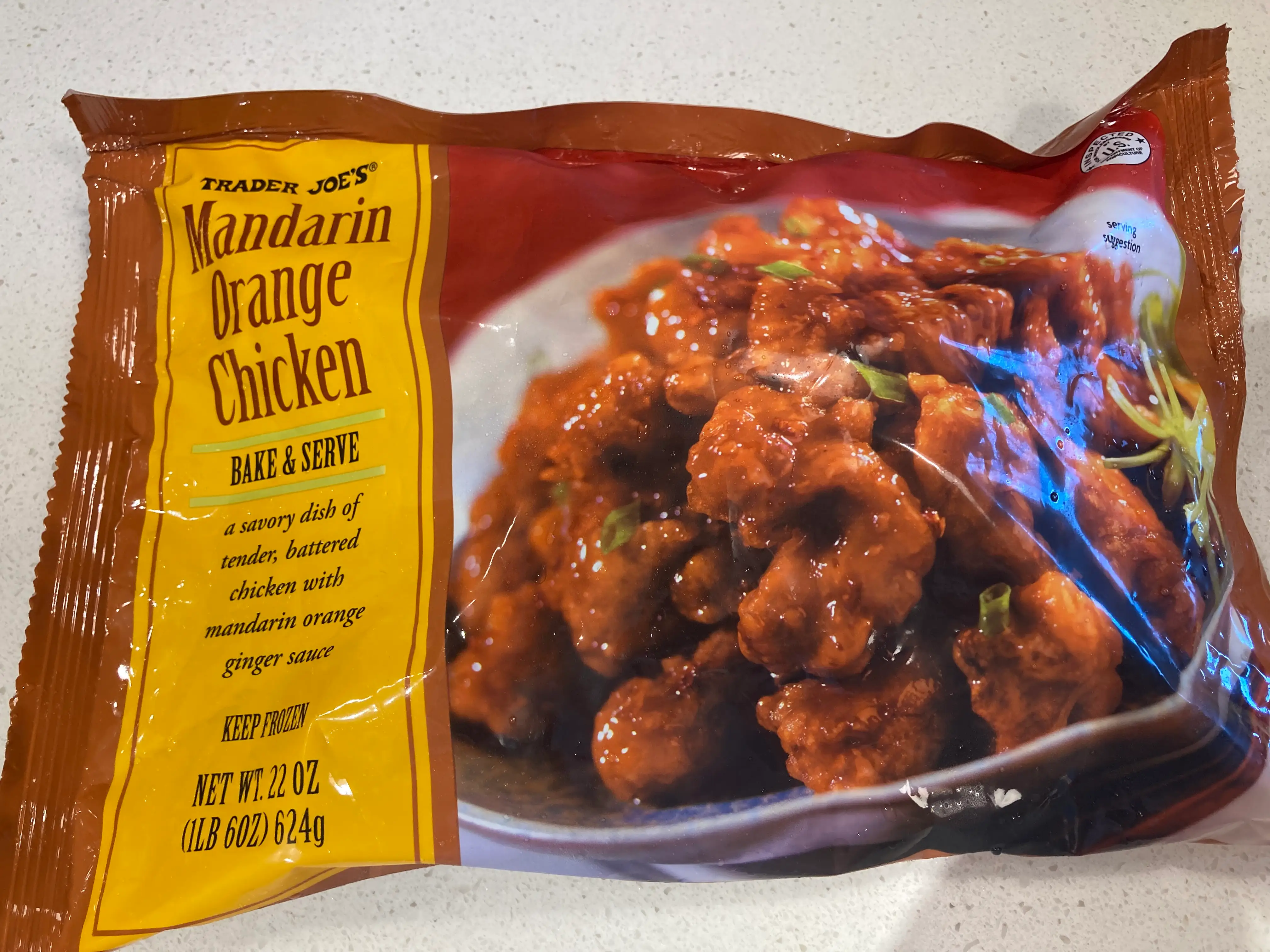 A bag of Trader Joe's Mandarin orange chicken sitting on table.