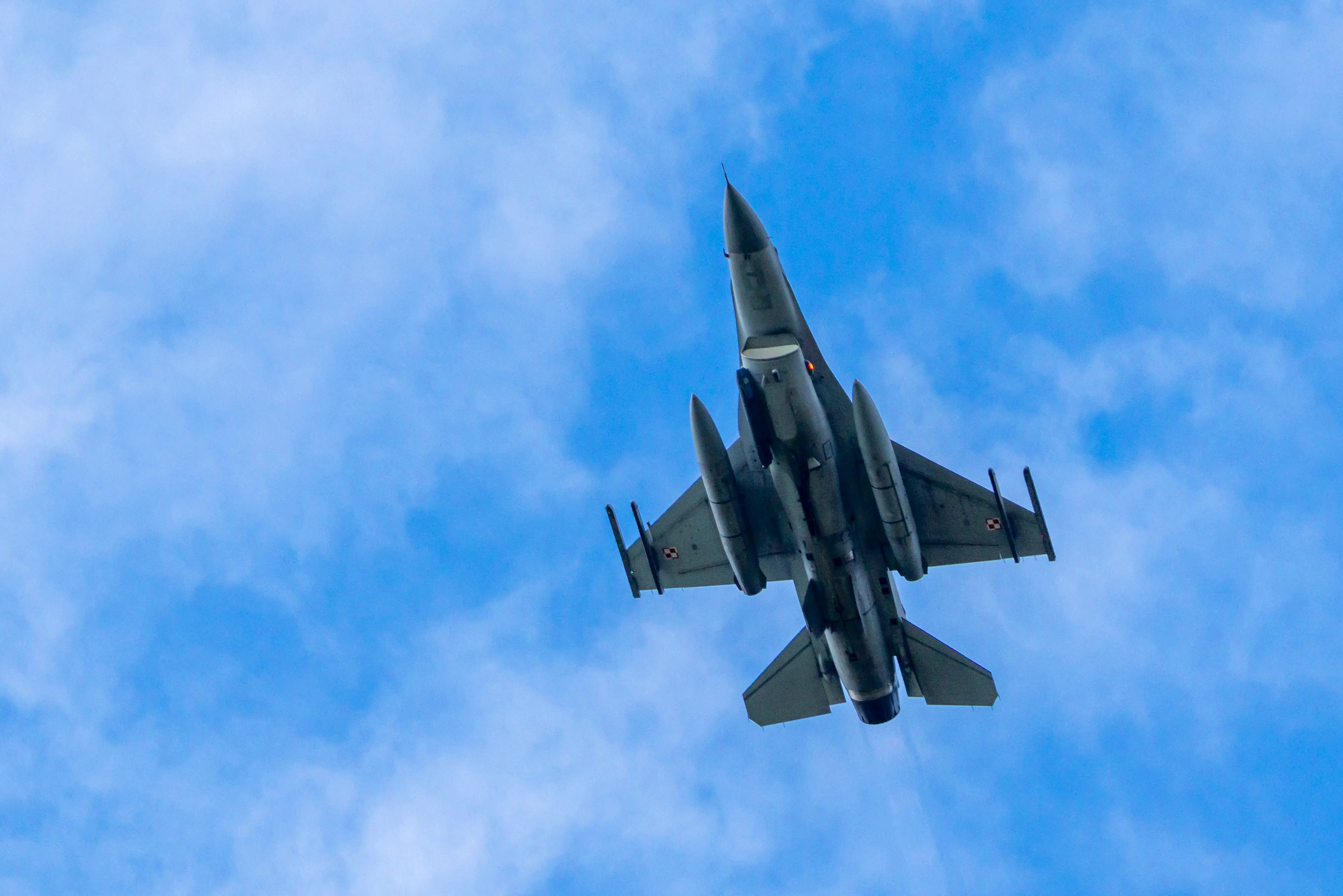 A Polish Air Force F-16 Fighting Falcon fighter jet flies over the Orzysz Land Forces Training Center during Operation Brave Boar 26 military exercise near the Suwalki Gap in Poland, on June 17, 2026.