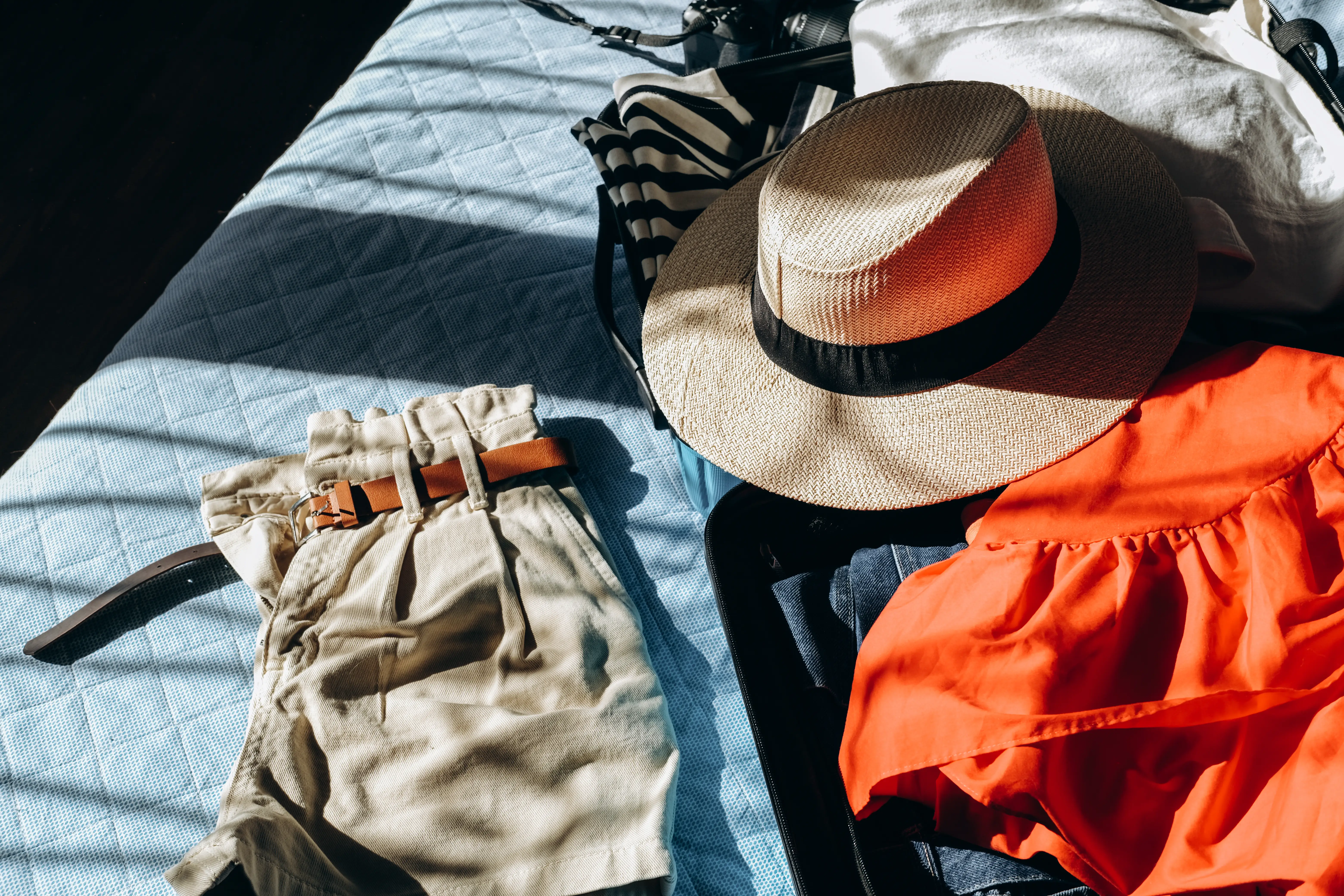 Clothes, hat on bed