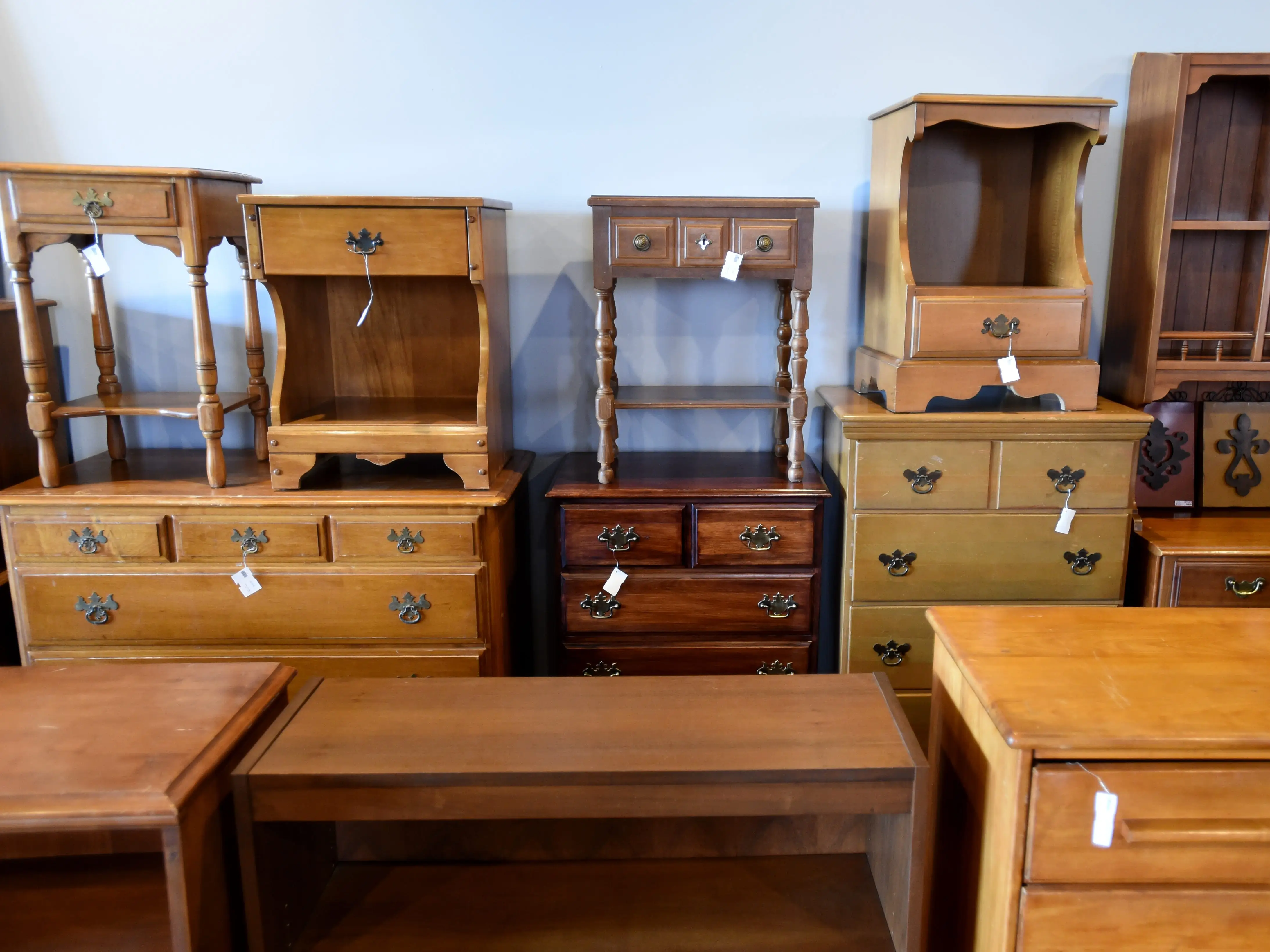 Pieces of vintage furniture in a thrift shop.