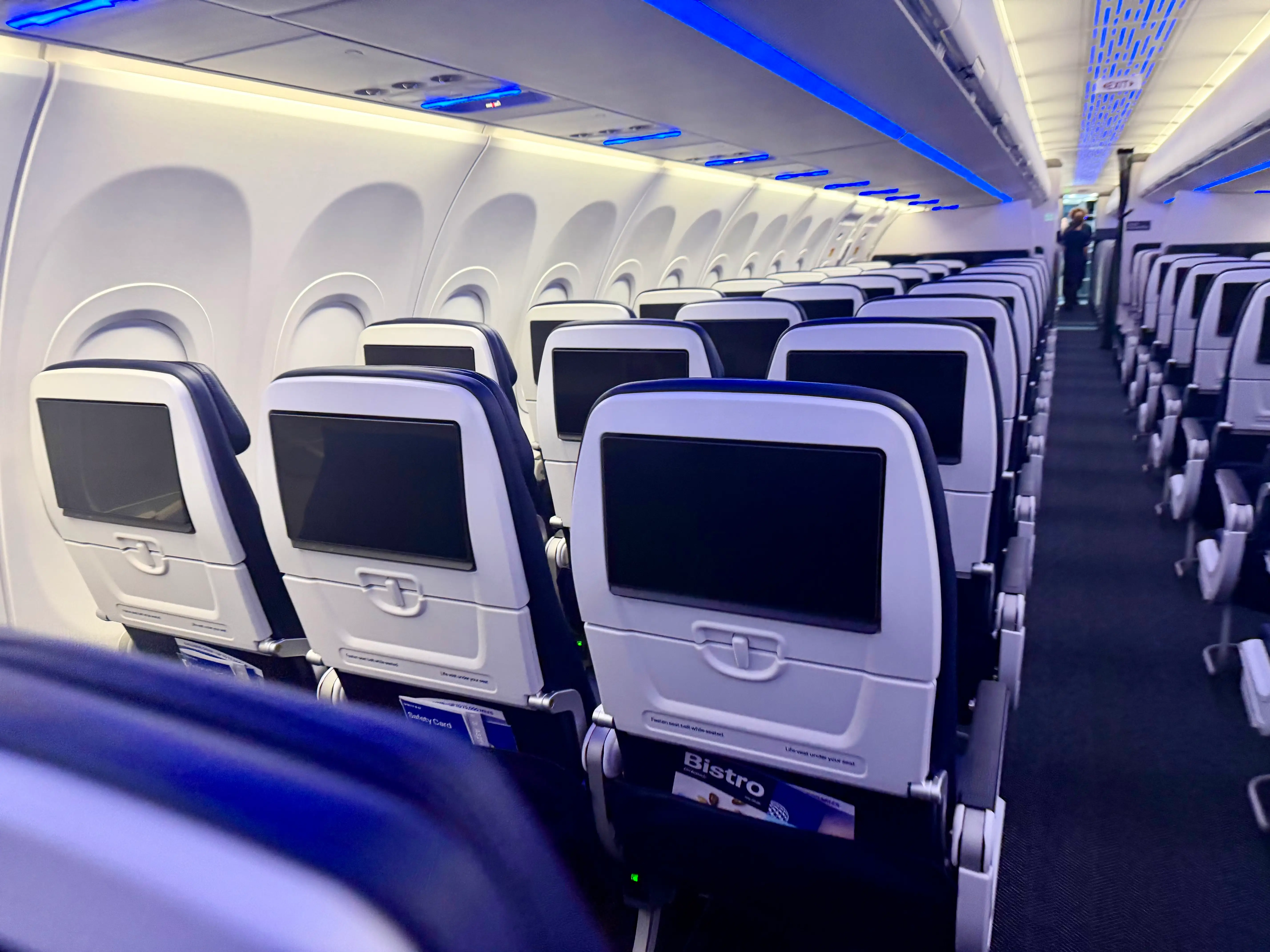 The economy cabin with seatback screens off.