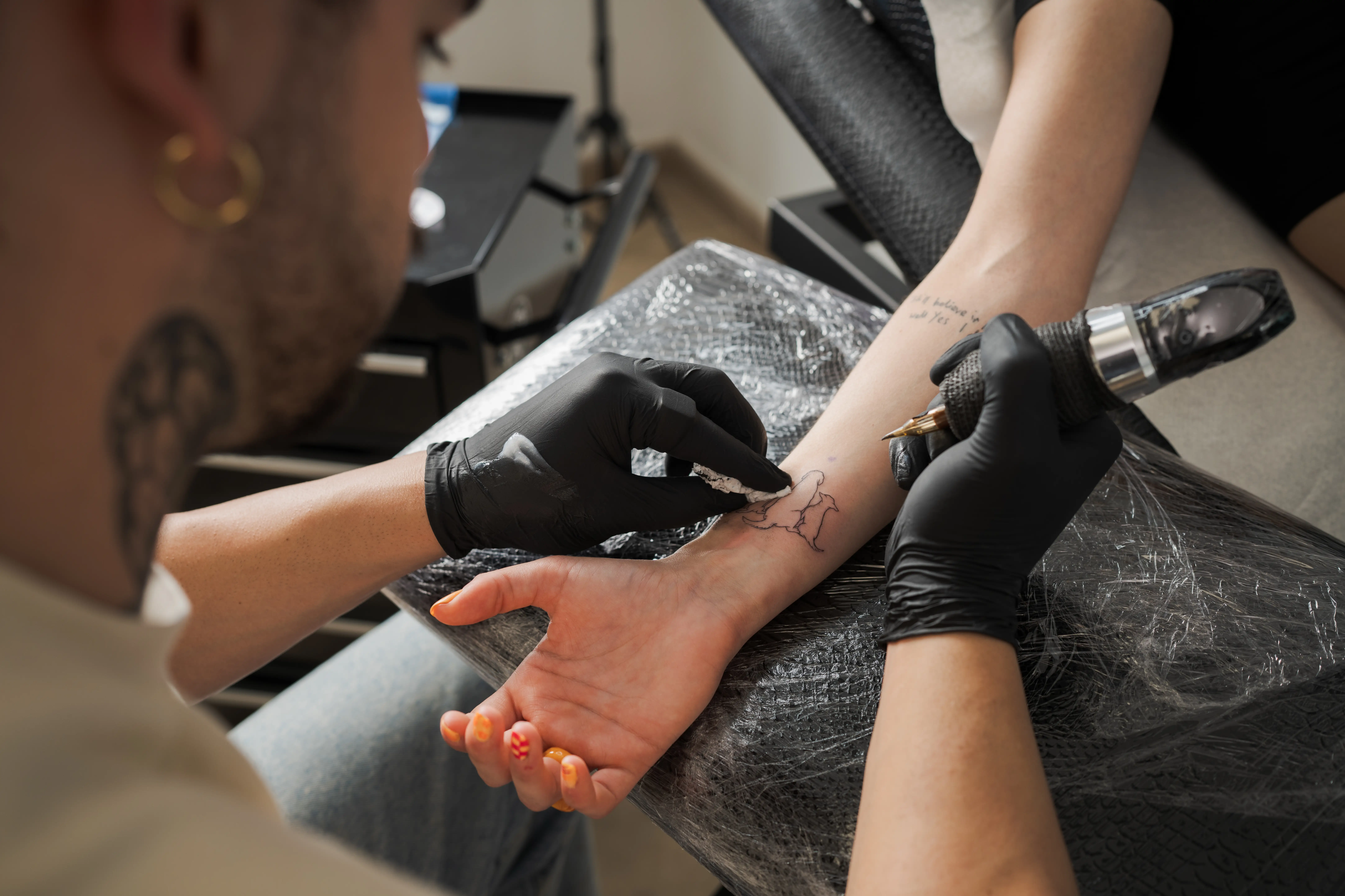A tattoo artist is pictured.