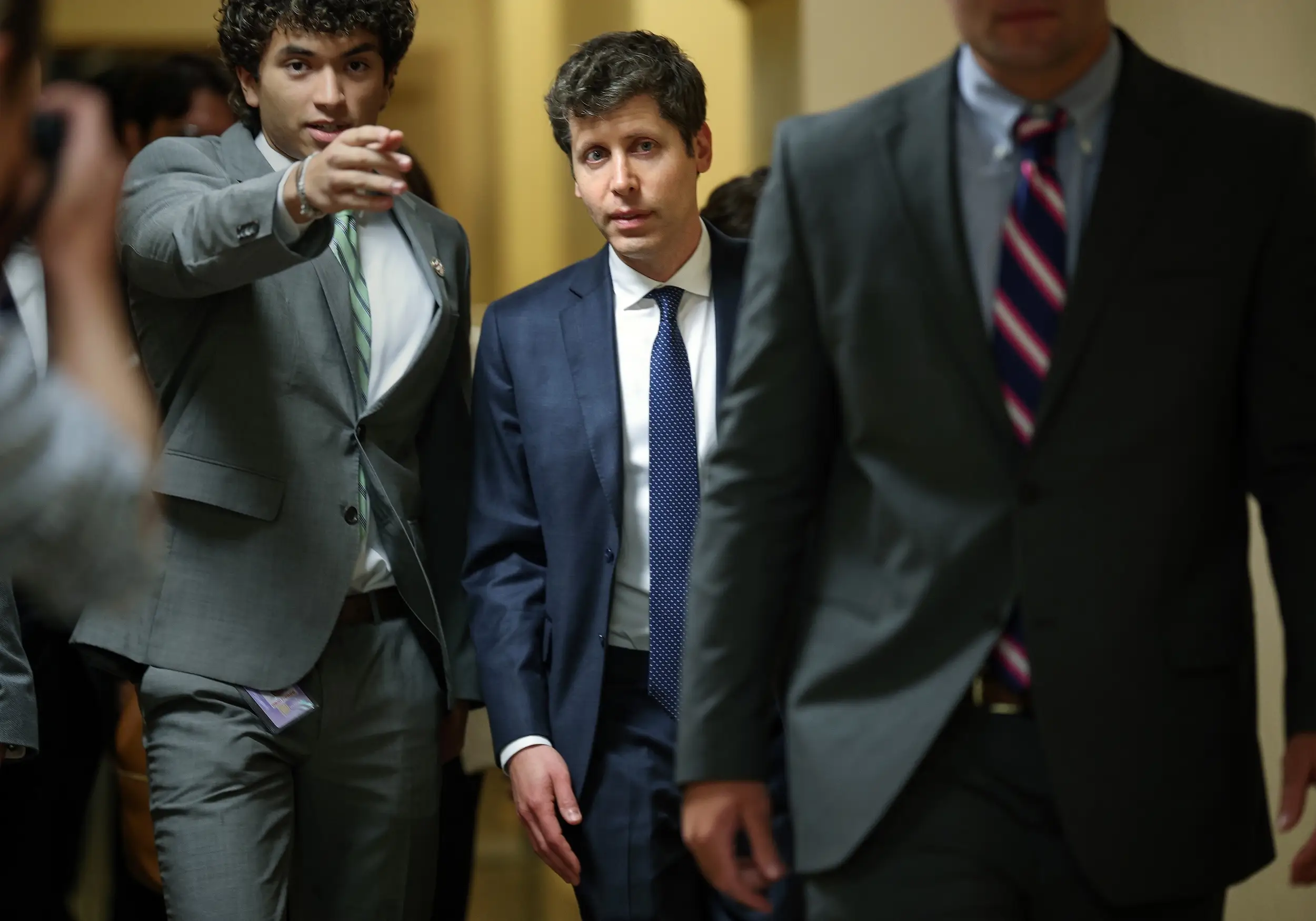 Sam Altman walks through the halls of Capitol Hill