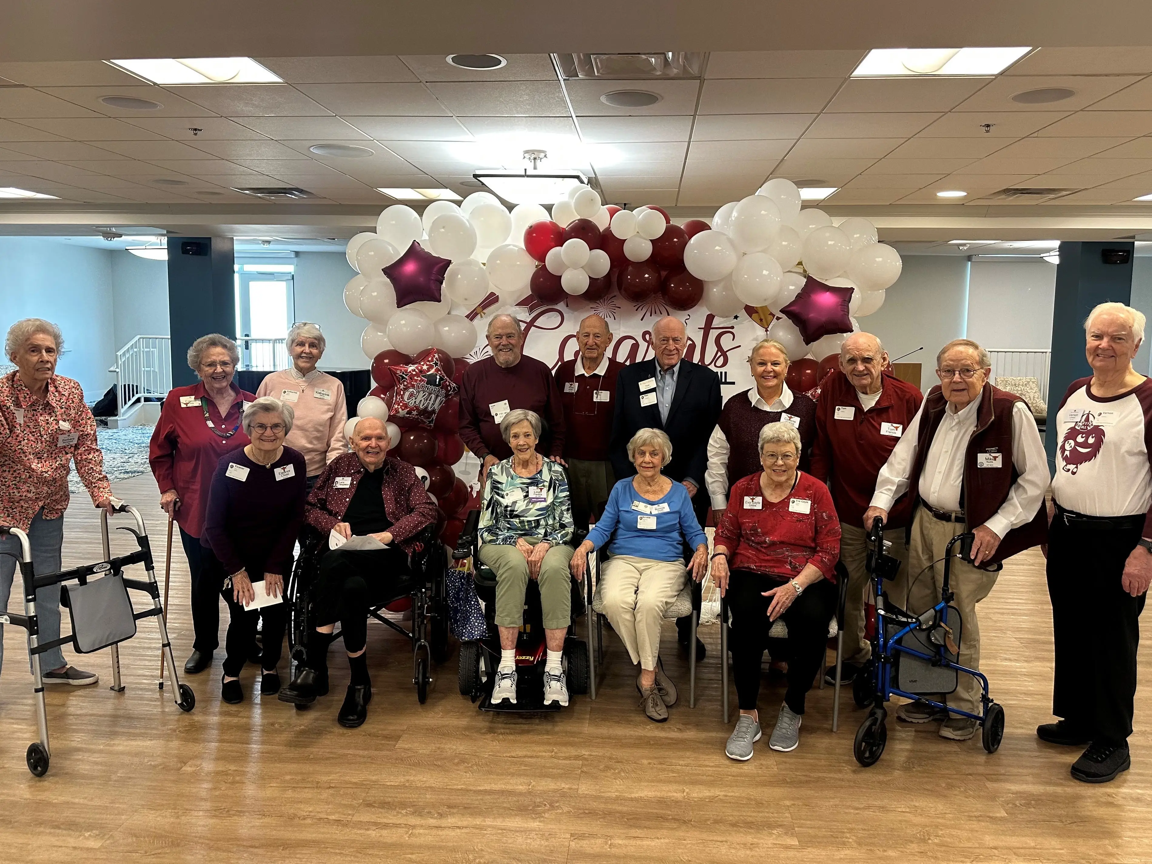 A group of older adults at a high school reunion