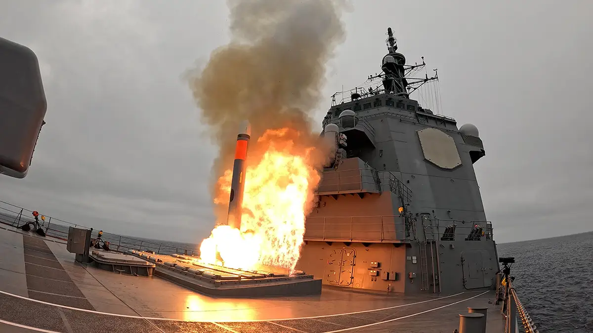A Tomahawk missile launches from a Japanese destroyer in the ocean.