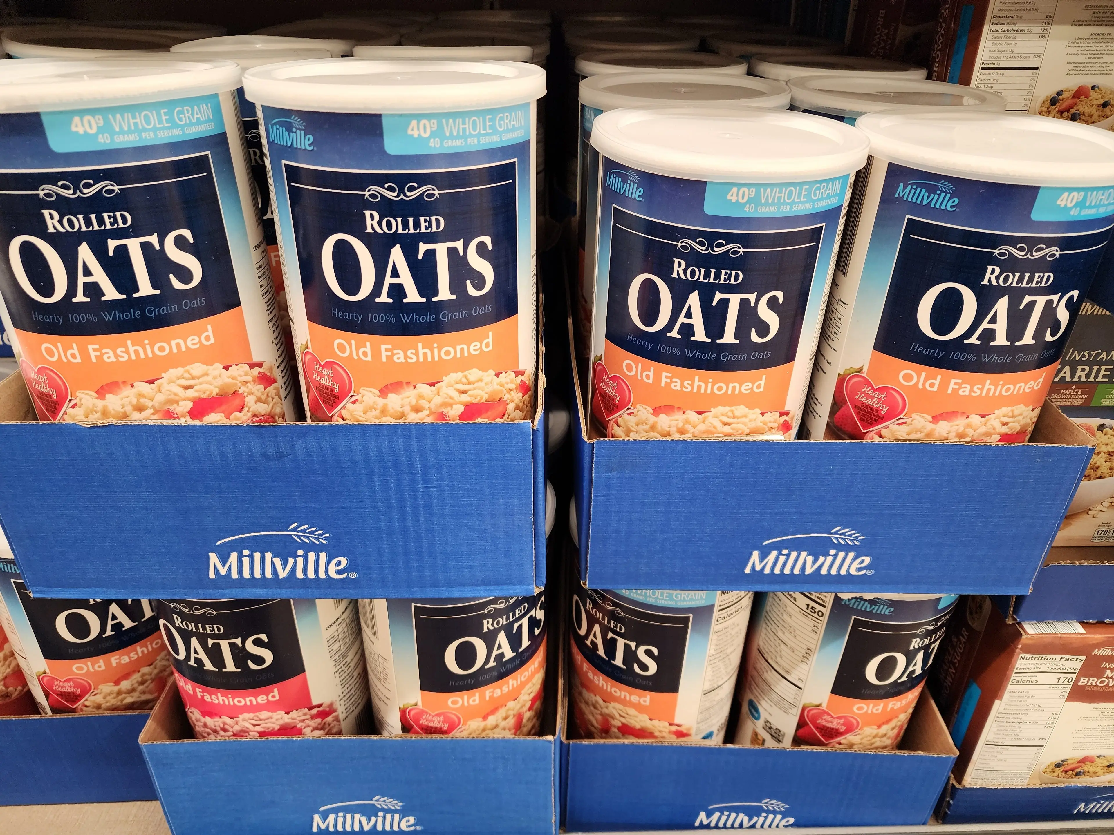 Several containers of Millville old-fashioned rolled oats sit in cardboard containers at Aldi.