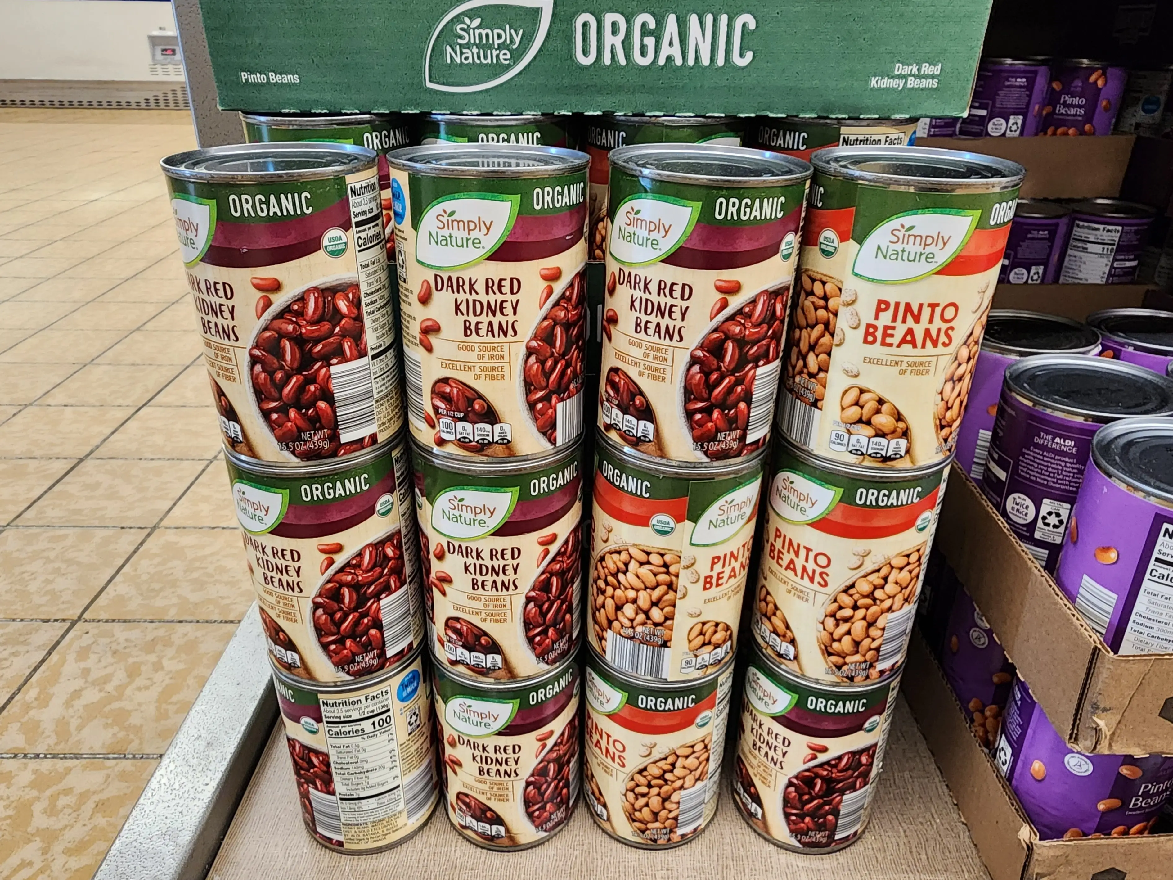 Simply Nature dark red kidney beans and pinto beans are stacked in a grocery store display at Aldi.