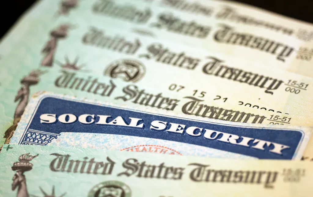 Social Security card on top of United States Treasury checks.