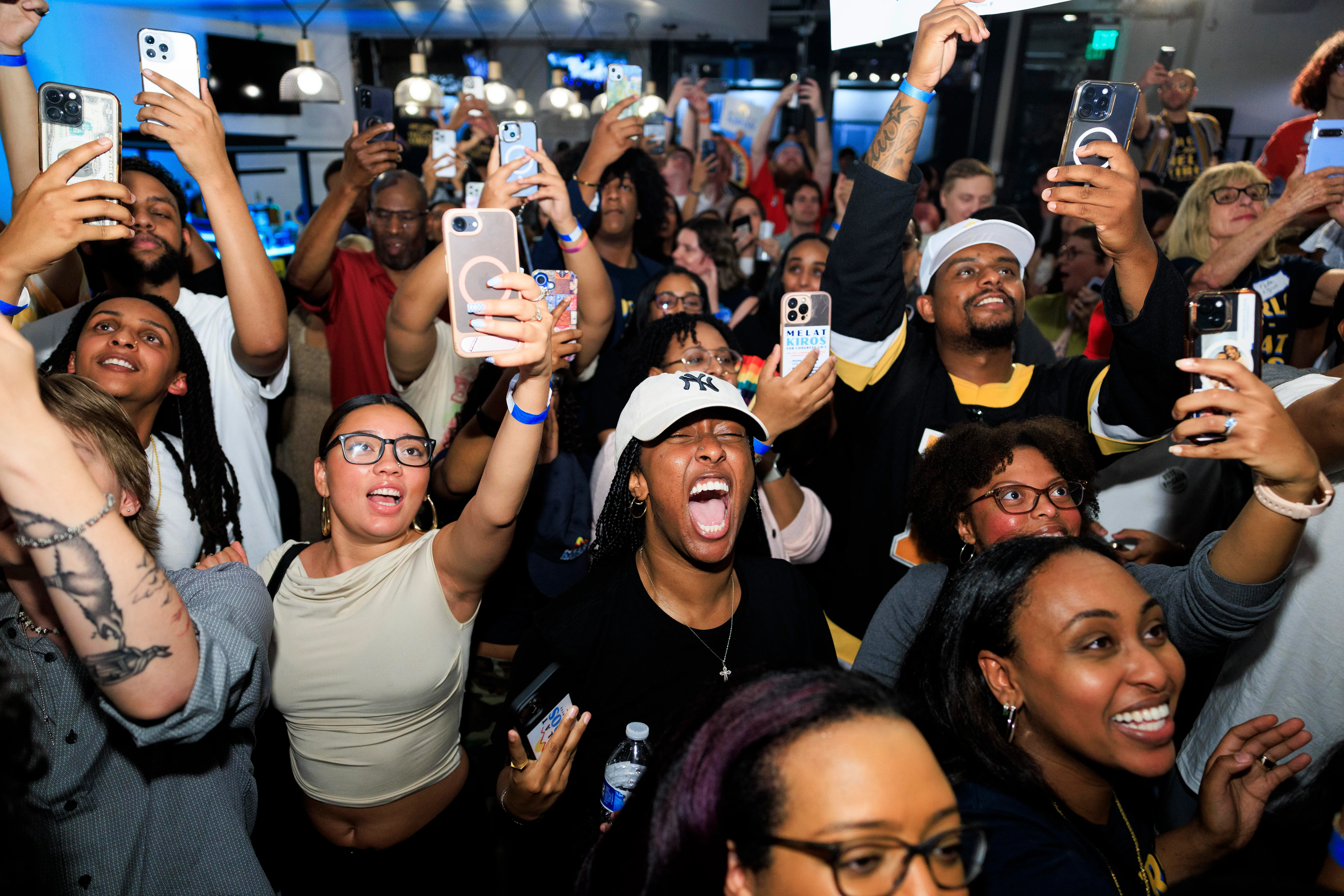 People celebrating in a crowd with their phones up