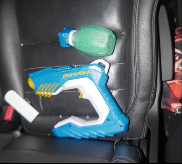 A blue and white toy gun, labeled 