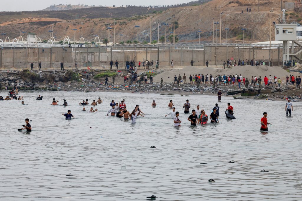 Migrants overrun a Spanish outpost, stirring White House outrage