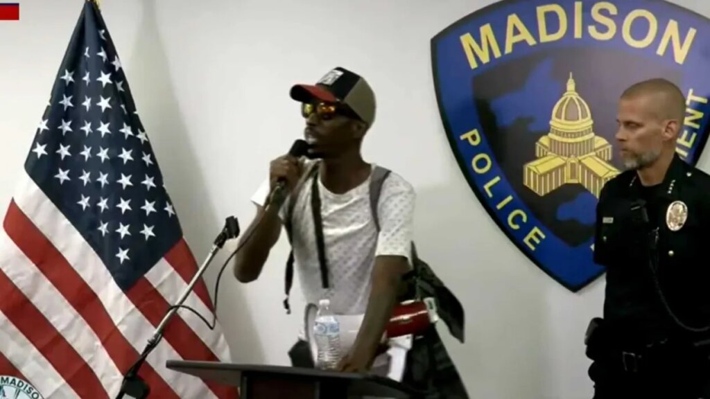 ‘Give me this microphone!’ Chaos as protesters take over police chief’s press conference