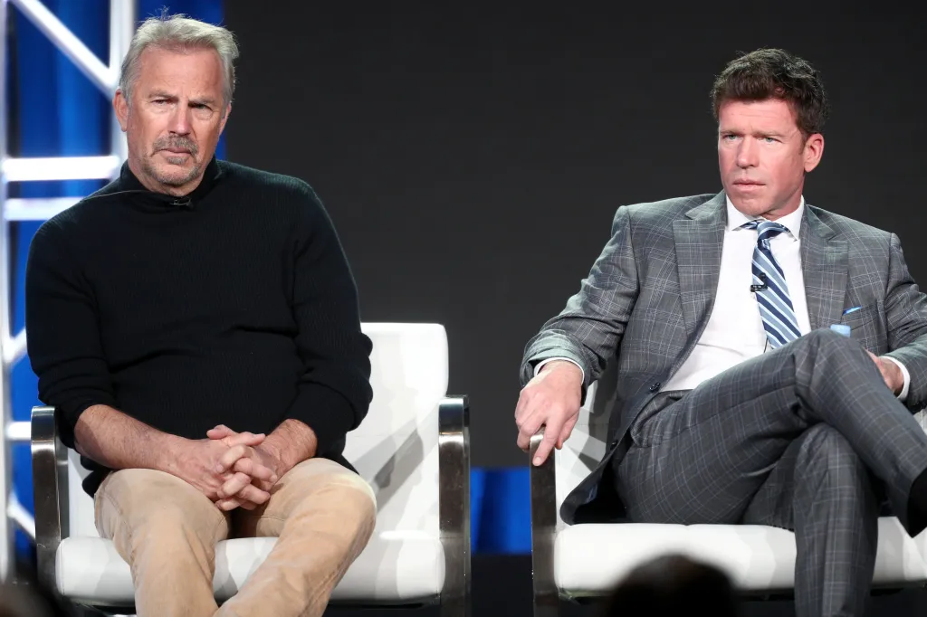 Actor Kevin Costner and producer/writer Taylor Sheridan of 'Yellowstone' speaking onstage.