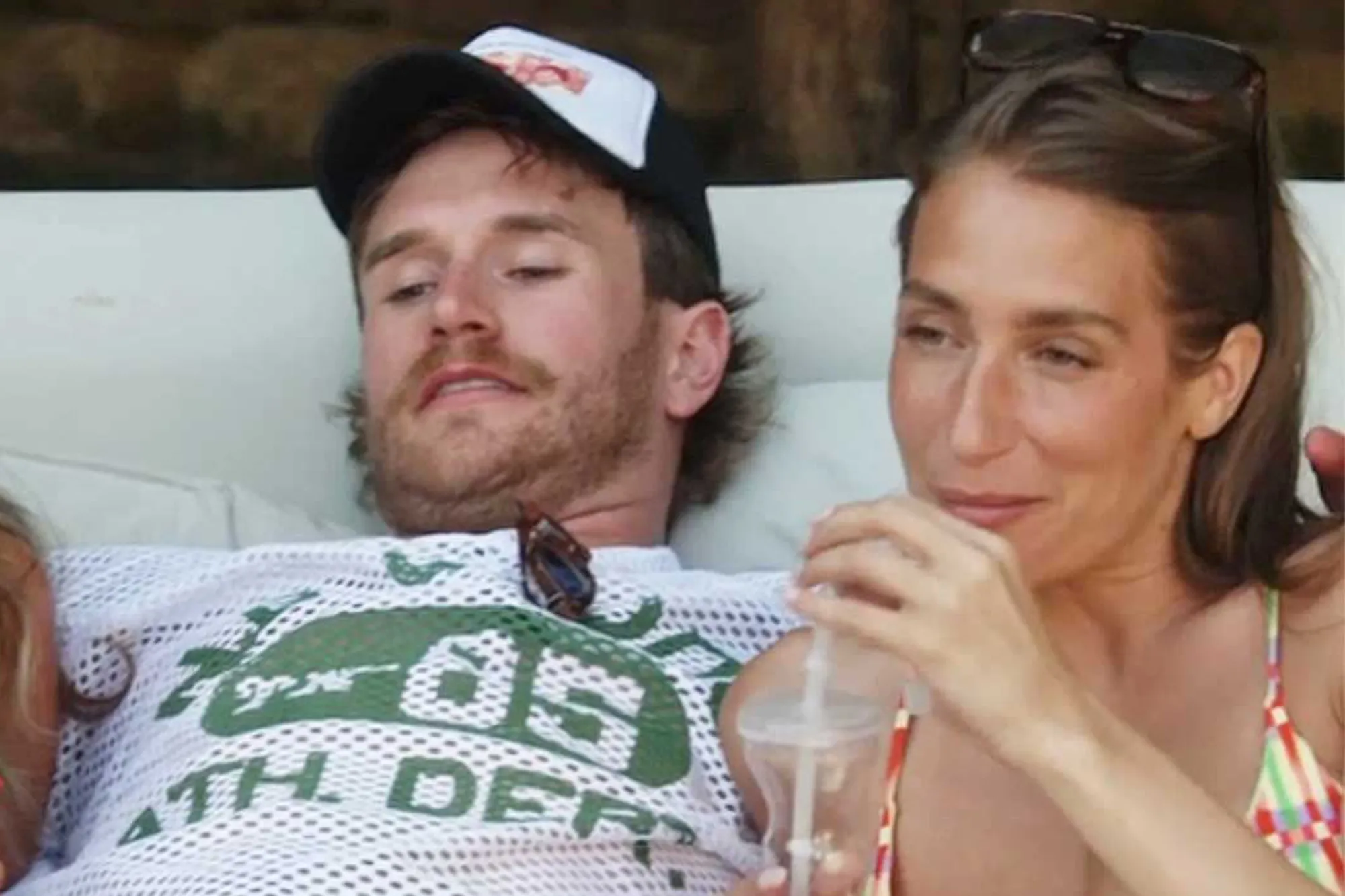 West Wilson in a white mesh shirt and Amanda Batula in a colorful bikini top.