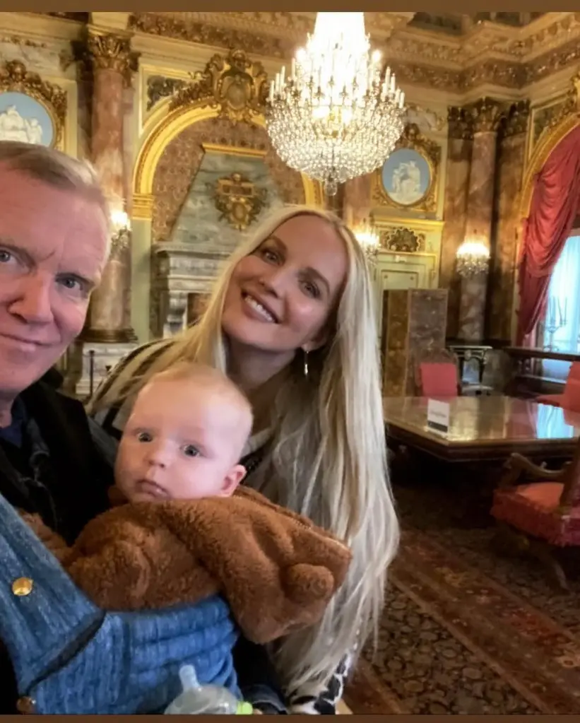 Anthony Michael Hall, his wife, and their baby in a formal room.