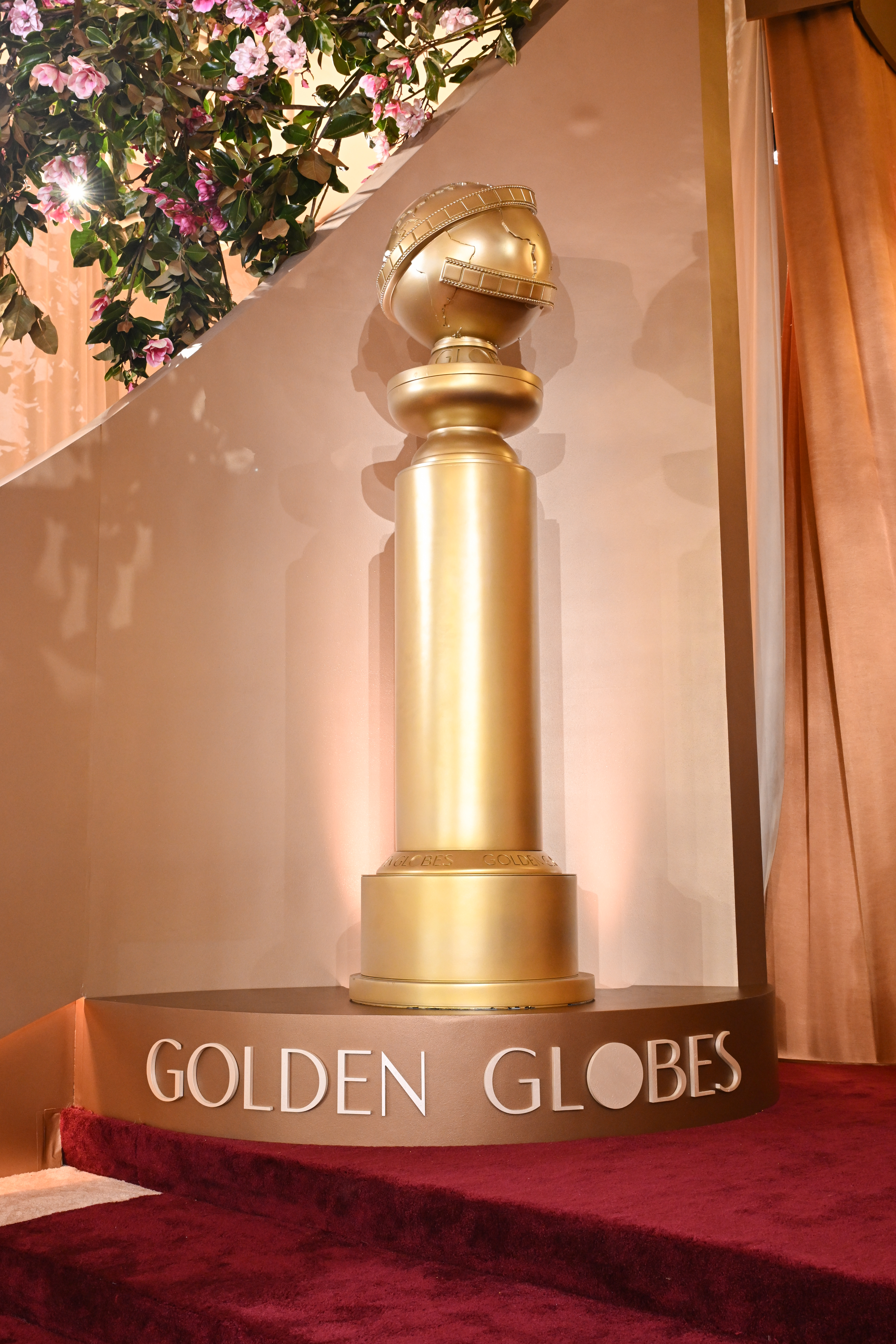 Golden Globes trophy on a red carpet with 