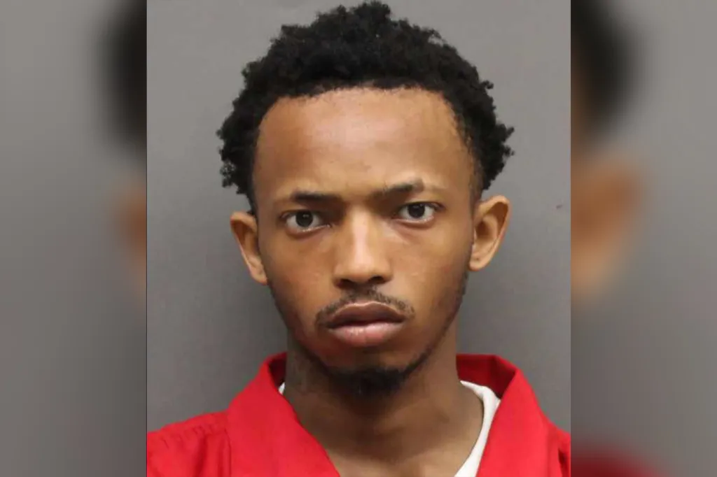 Mugshot of a young Black man, Butler, with short dark hair, wearing a red shirt, looking directly at the camera.
