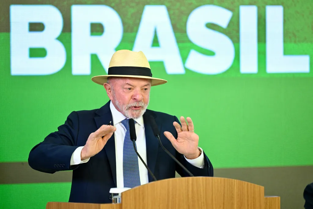 Brazilian President Luiz Inacio Lula da Silva speaks at a podium with the word