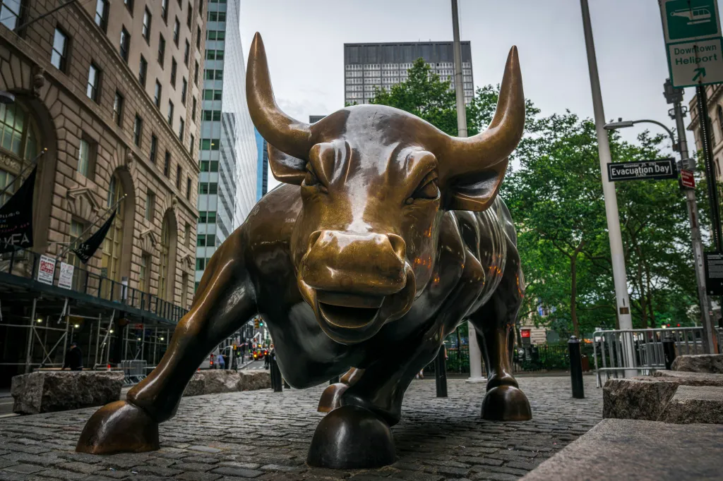 The bronze 'Charging Bull' sculpture stands on Broadway near Bowling Green in the Financial District of New York City.