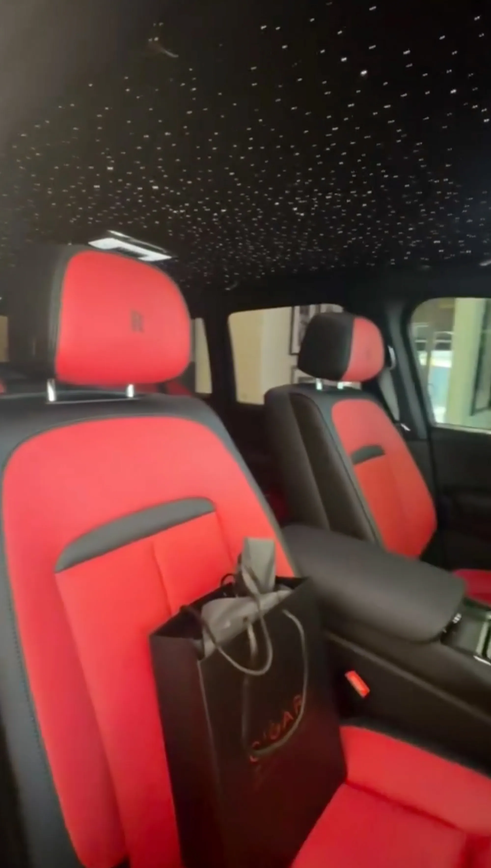 Interior of a Rolls-Royce with black and red leather seats and a