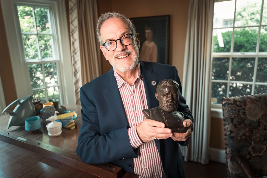 Ulysses Grant Dietz holding a bust of President Ulysses S. Grant.