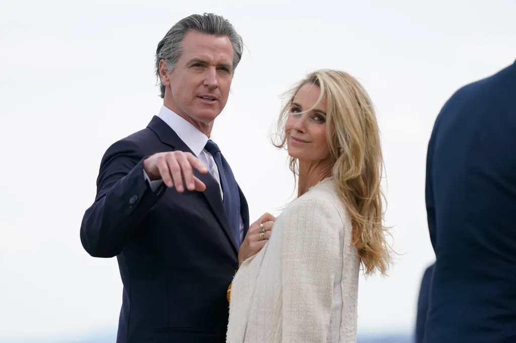 California Gov. Gavin Newsom and his wife Jennifer Siebel Newsom wait to greet President Joe Biden.