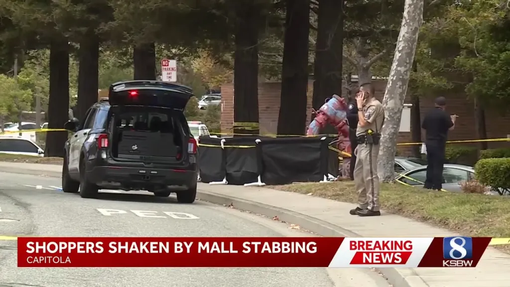Police car with trunk open and officers on scene at the Capitola Mall following a deadly stabbing.