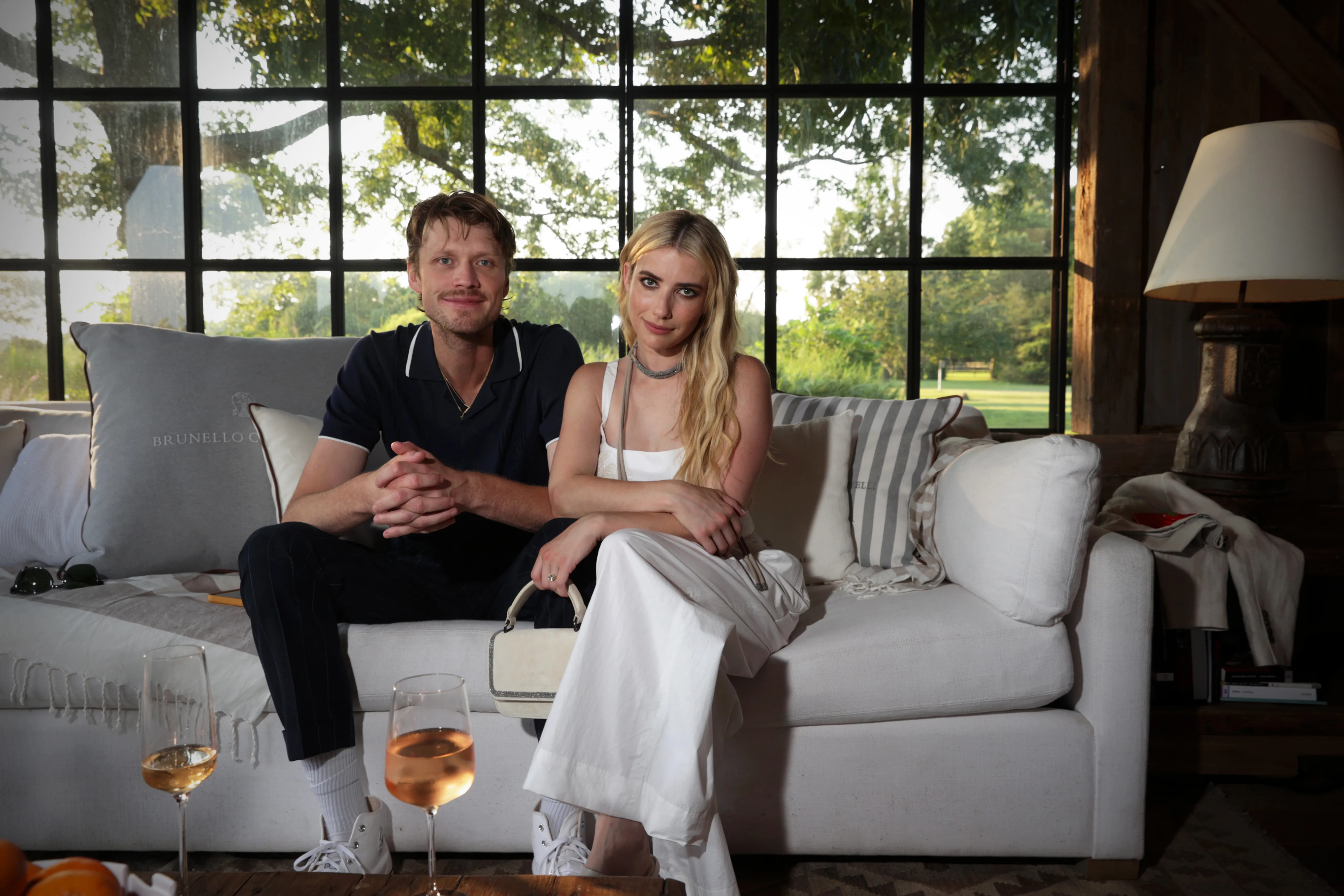 Emma Roberts and Cody John sitting on a couch.