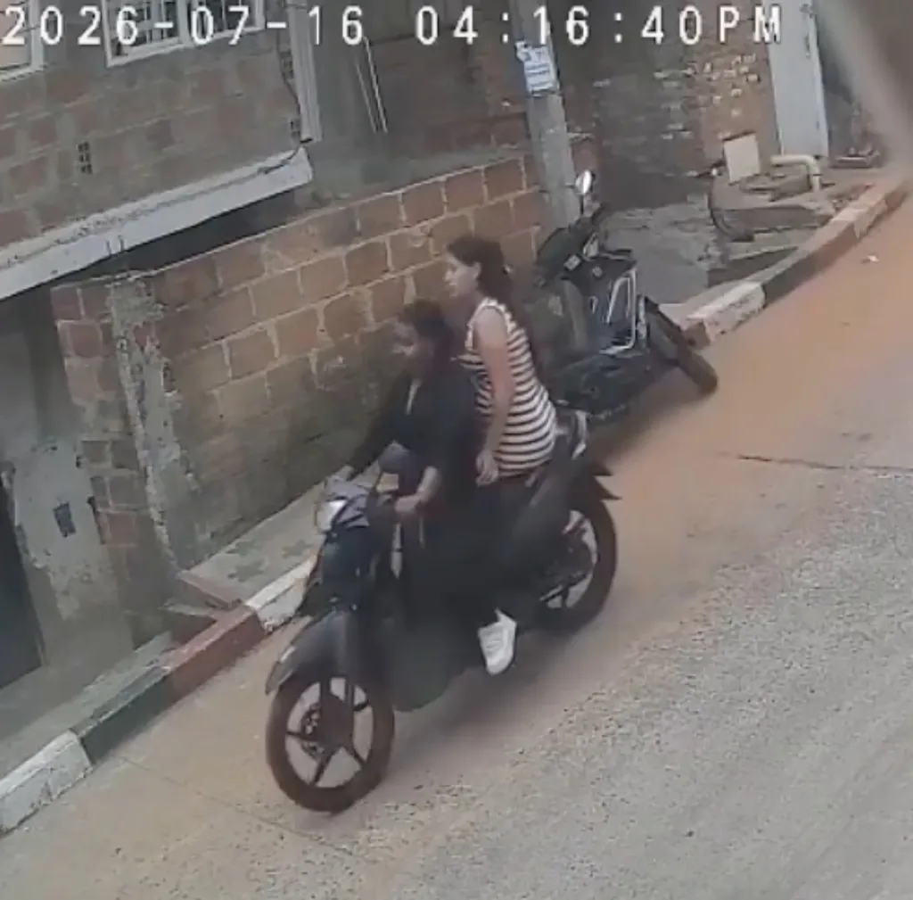CCTV footage showing two women riding a motorcycle.