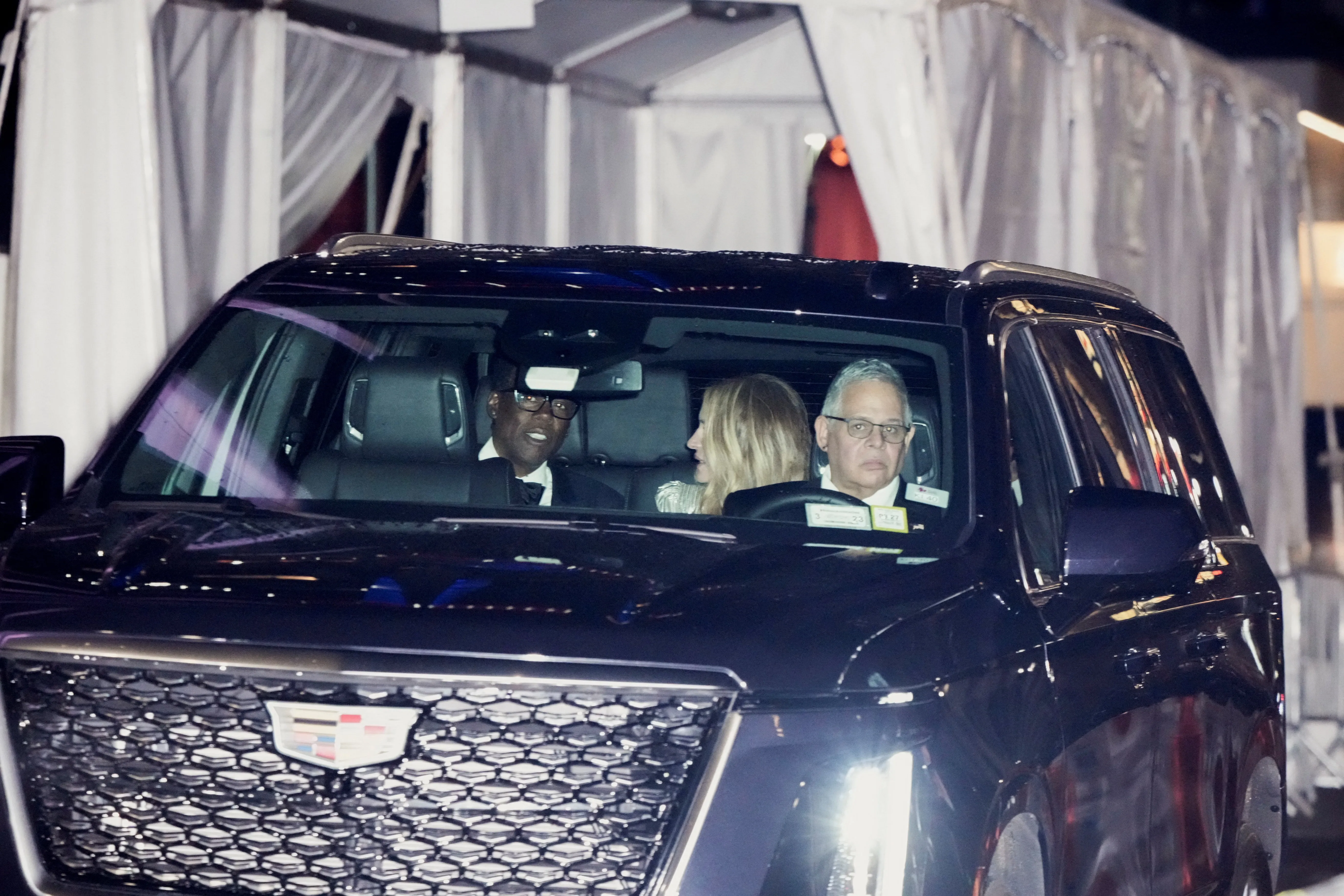 Comedian Chris Rock reacts from inside a vehicle as he departs Madison Square Garden.