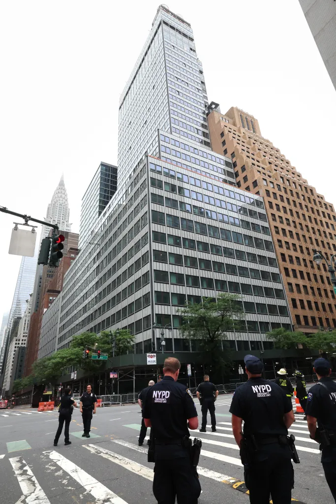 NYPD officers and firefighters gathered near a New York City building under construction following a structural collapse.