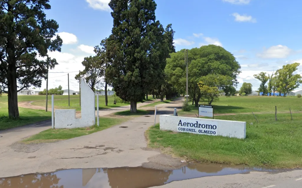 Entrance to Coronel Olmedo airfield with a sign that reads 