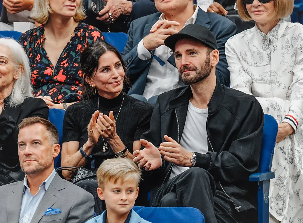 Courteney Cox and Johnny McDaid applaud at the US Open Tennis Championships.