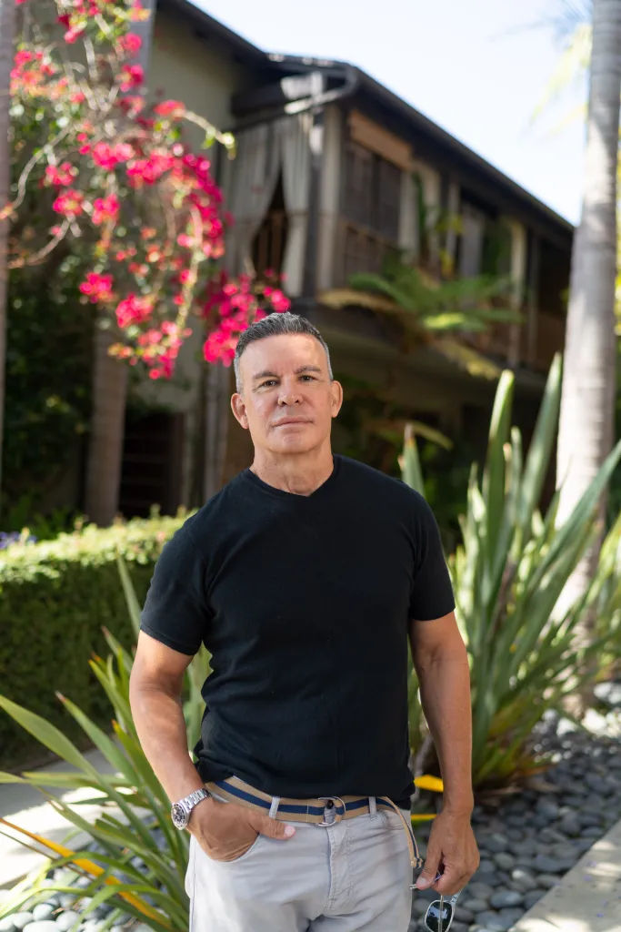Craig Ribeiro, owner of a four-unit apartment building, stands outside his property.
