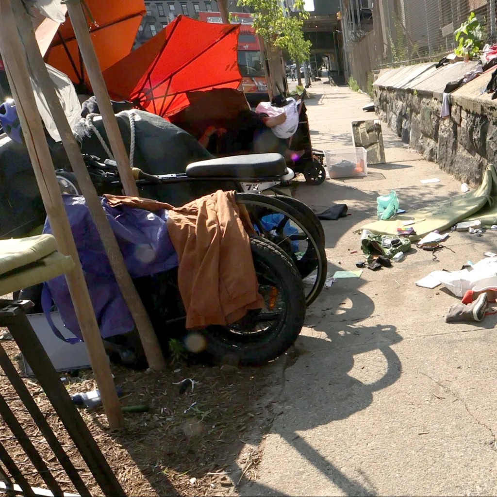 A homeless encampment blocks a sidewalk on West 45th Street between 11th and 12th avenues in Midtown Manhattan.