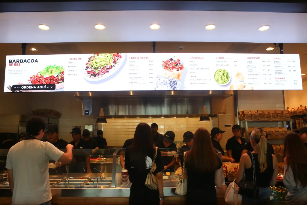 Customers ordering food at a Chipotle restaurant in Mexico.