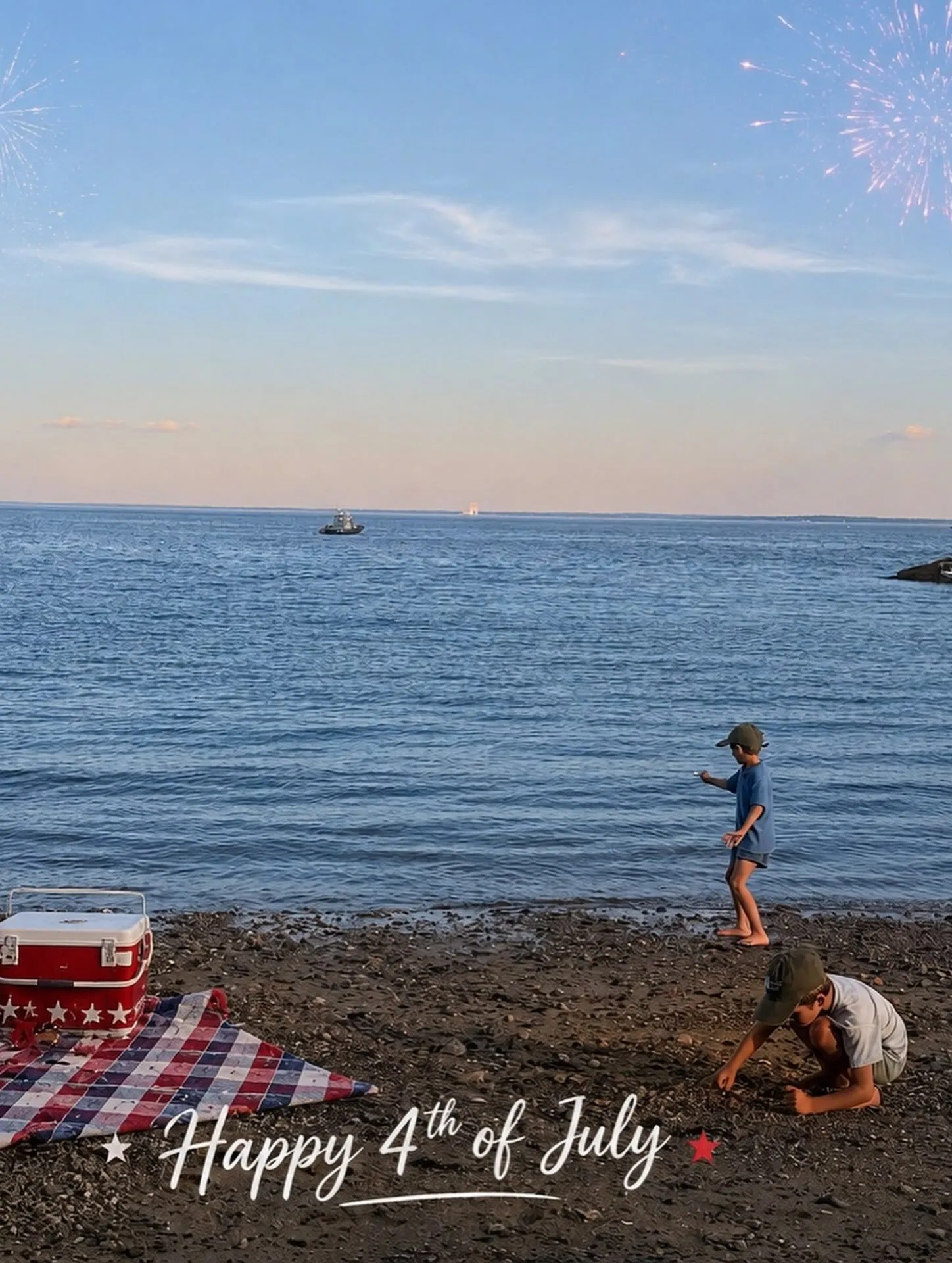 Two children playing on a beach with fireworks in the sky and