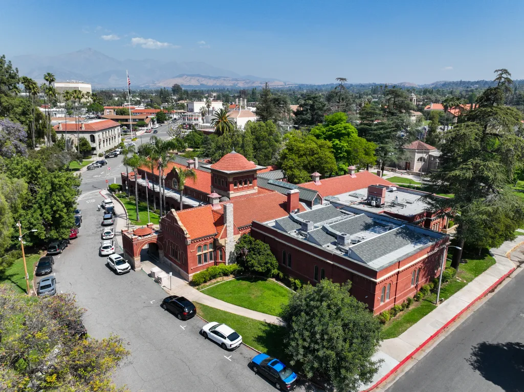 A drone view of downtown Redlands, California, with the Smiley Library in the central park.