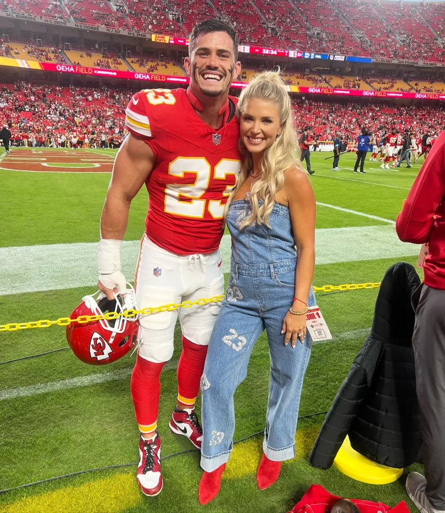Drue and Jackie Tranquill posing on a football field.