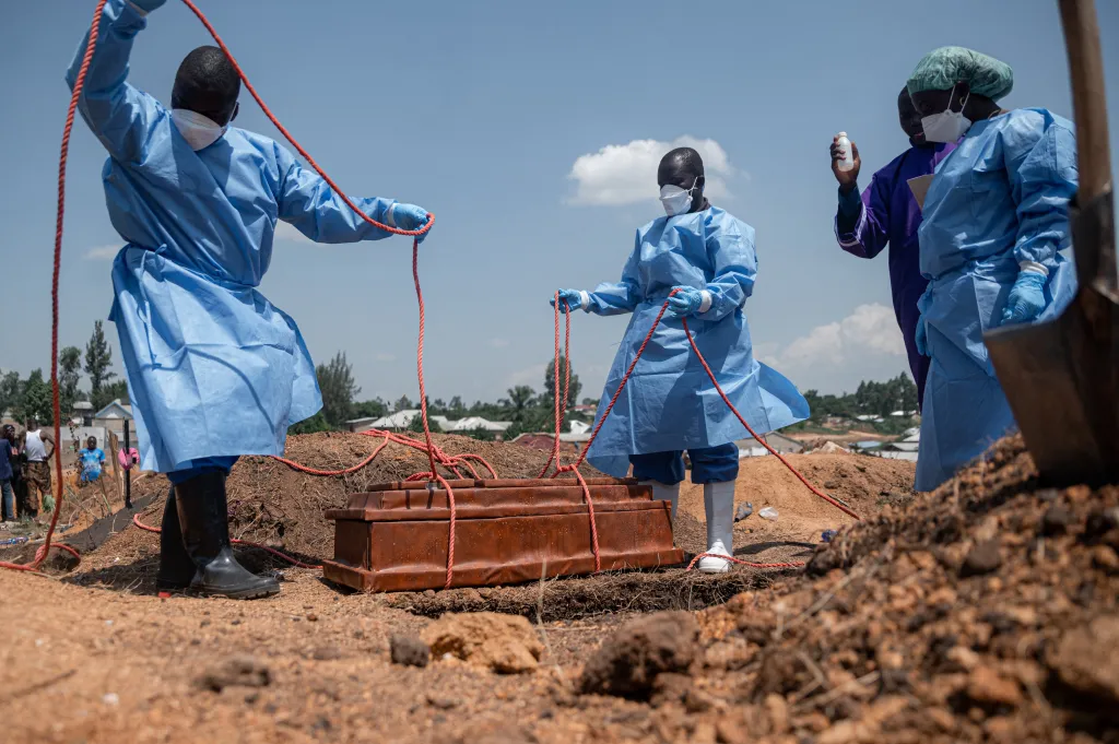 Teams from the International Federation of the Red Cross and Red Crescent Societies prepare for burial at Mbiyo cemetery the body of a fourth orphan who died from Ebola virus disease at an orphanage in Bunia, Ituri Province, June 19, 2026.