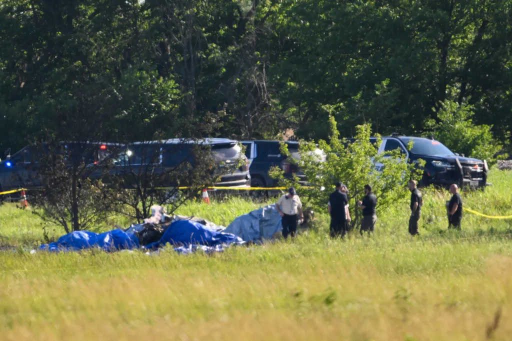 Emergency personnel investigate the site of a plane crash at the Butler Memorial Airport in Butler, Mo.