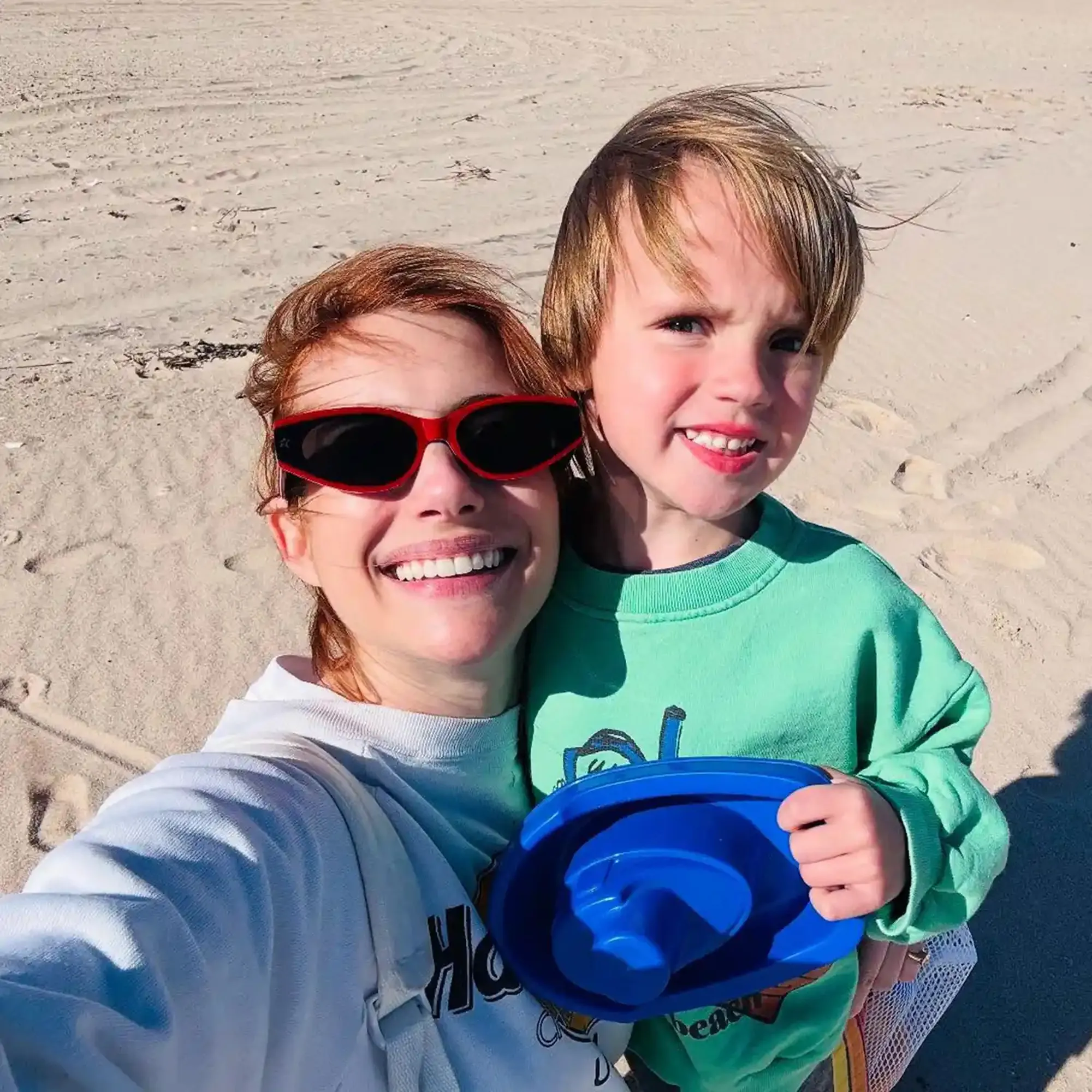 Emma Roberts and her son Rhodes Robert smiling at the beach.